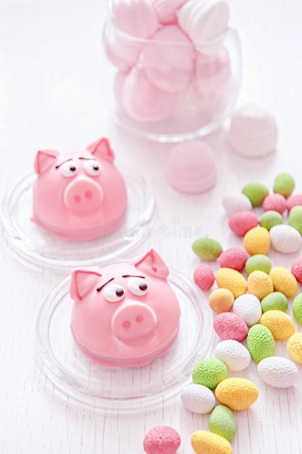 Marzipan in the shape of the symbol of the new year - pink pig, sweet delicate macaroons, marshmallows, peanuts in sugar