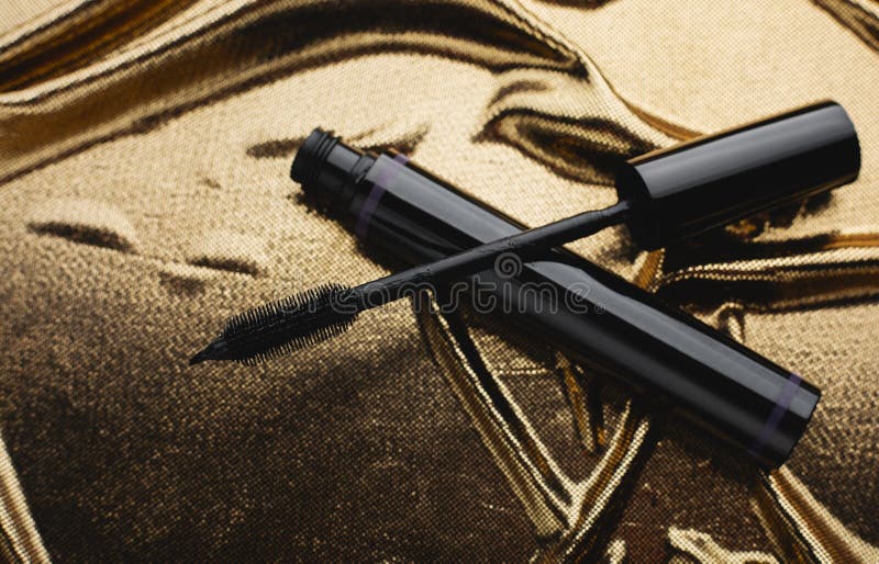 Mascara on gold background stock photo. Image of care 184185118