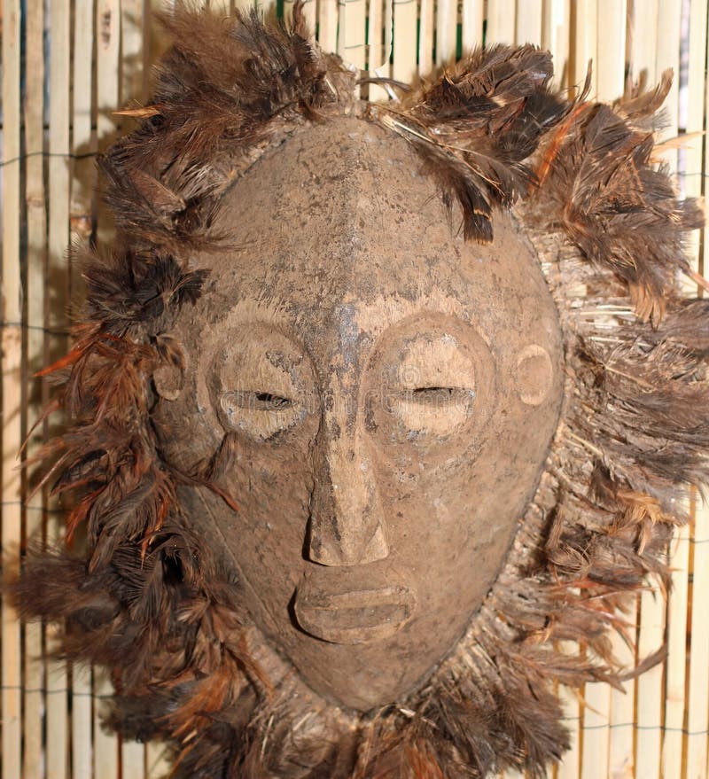 African wood mask used by sorcerers and shamans during ceremonies in African village. African wood mask used by sorcerers and shamans during ceremonies in African village