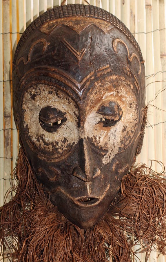 African wood mask used by sorcerers and shamans during ceremonies in village. African wood mask used by sorcerers and shamans during ceremonies in village