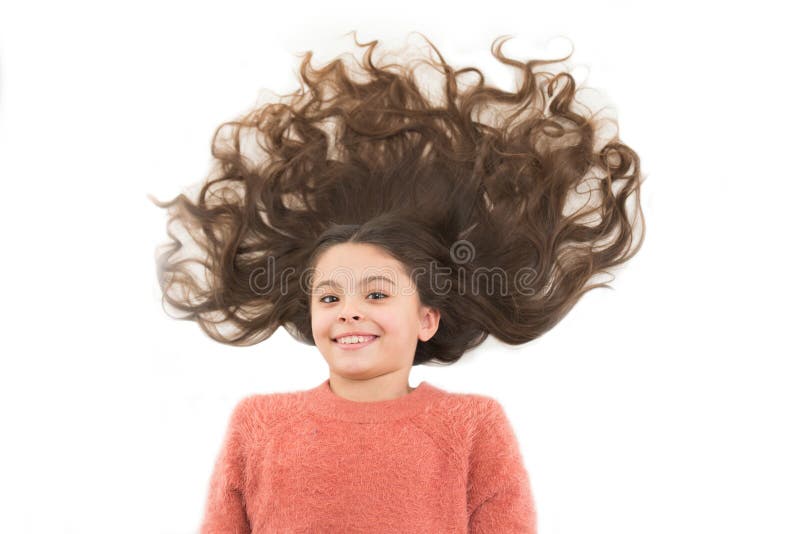 Maschere casalinghe naturali dei capelli che vi danno i bei capelli sani Bambino sveglio della ragazza con capelli ricci lunghi i immagine stock Maschere casalinghe naturali dei capelli che vi danno i bei capelli sani Bambino sveglio della ragazza con capelli ricci lunghi i immagine stock