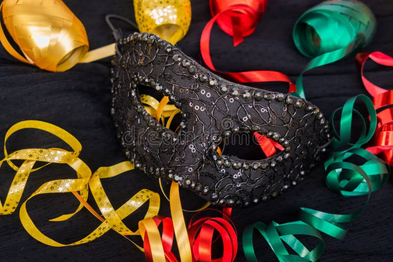 Masquerade decorations on dark wooden background Stock Photo by