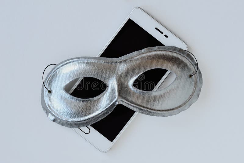 Mask on mobile phone - Concept of privacy, security and anonymity of mobile phones. Mask on mobile phone. Concept of privacy, security and anonymity of mobile stock photography Mask on mobile phone - Concept of privacy, security and anonymity of mobile phones. Mask on mobile phone. Concept of privacy, security and anonymity of mobile stock photography