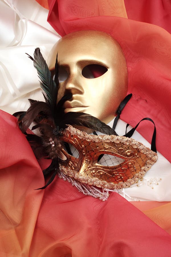 Golden venetian masks on a textile. Golden venetian masks on a textile