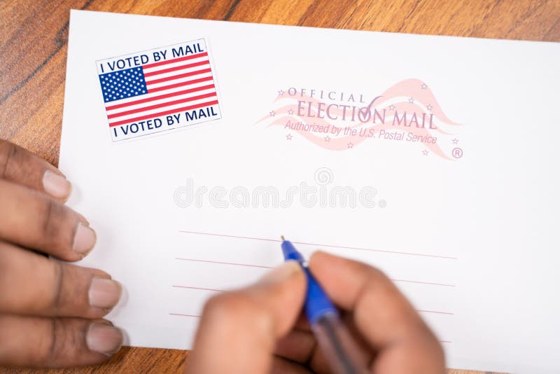 Maski, India - 23, June 2020 : Hands filling out mail postel stamp, concept of voted by mail during US election.