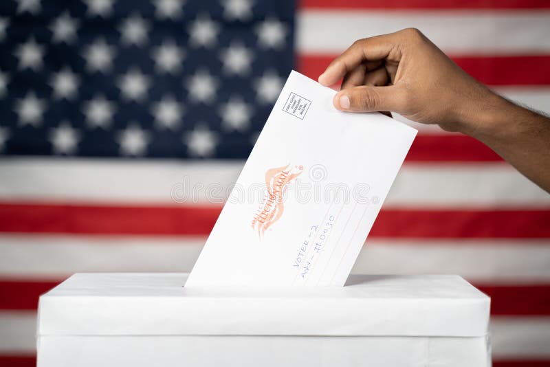 Maski, India 14 September, 2020 : Concept of Mail in vote at US election - hands dropping mail inside the ballot box with us flag as background