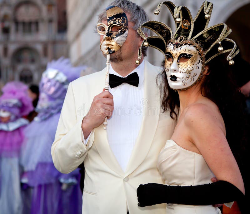 VENICE, ITALY - February 17, 2012: Unidentified persons in Venice masks at St. Mark's Square, Carnival of Venice on February 17, 2012. Annual carnival was held in 2012 from February 11 to February 21, 2012. VENICE, ITALY - February 17, 2012: Unidentified persons in Venice masks at St. Mark's Square, Carnival of Venice on February 17, 2012. Annual carnival was held in 2012 from February 11 to February 21, 2012.