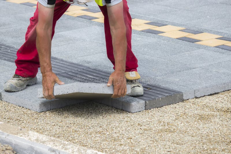 Mason hands laying paver bricks, paver making sidewalk. Selective focus and shallow dof. Bricklayer tiler stock images, royalty-free photos and pictures