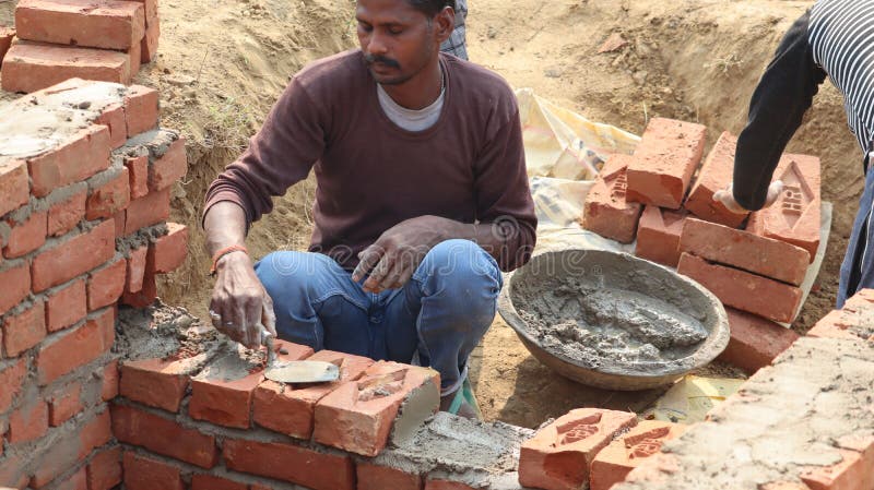 A Mason is Joining Brick with Cement To Create a Wall. Editorial ...