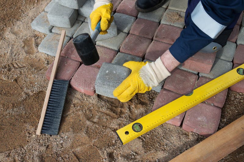 Mason worker making sidewalk pavement with stone blocks. Bricklayer tiler stock images, royalty-free photos and pictures