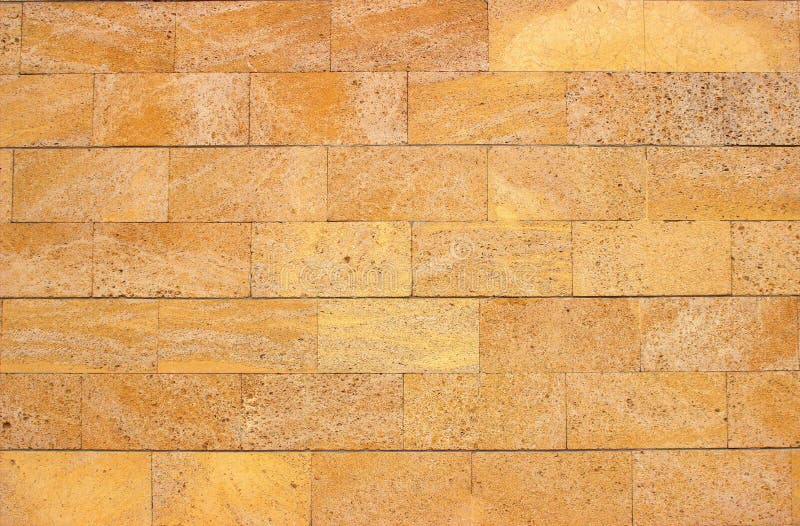 Masonry Made of Smooth, Processed Yellow Limestone Stones Stock Photo