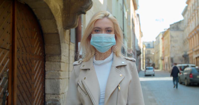 Virus mask woman on street wearing face protection in prevention for coronavirus covid 19. Lady walking in public space on quarantine for food. Virus mask woman on street wearing face protection in prevention for coronavirus covid 19. Lady walking in public space on quarantine for food