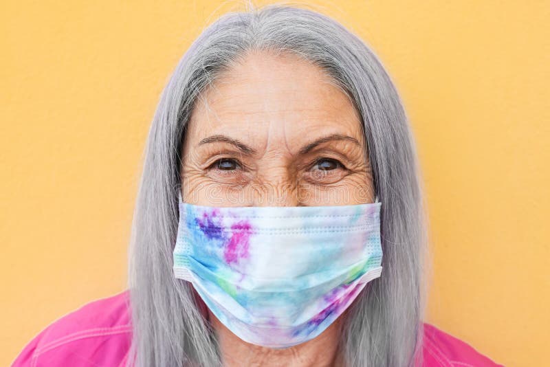 Happy senior woman wearing face mask during coronavirus outbreak - Covid-19 lifestyle. Happy senior woman wearing face mask during coronavirus outbreak - Covid-19 lifestyle