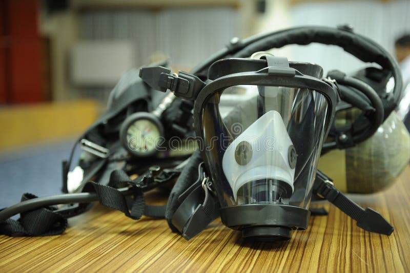 A protective mask with a respirator on a table. A protective mask with a respirator on a table.