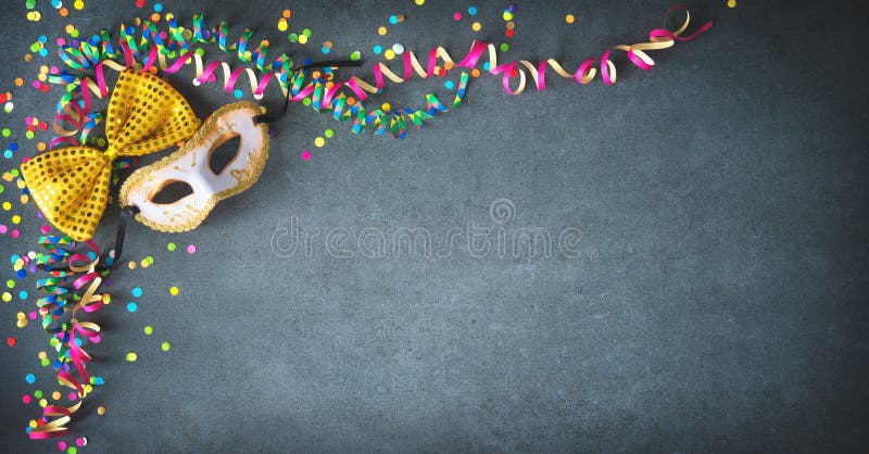 Masquerade decorations on dark wooden background Stock Photo by