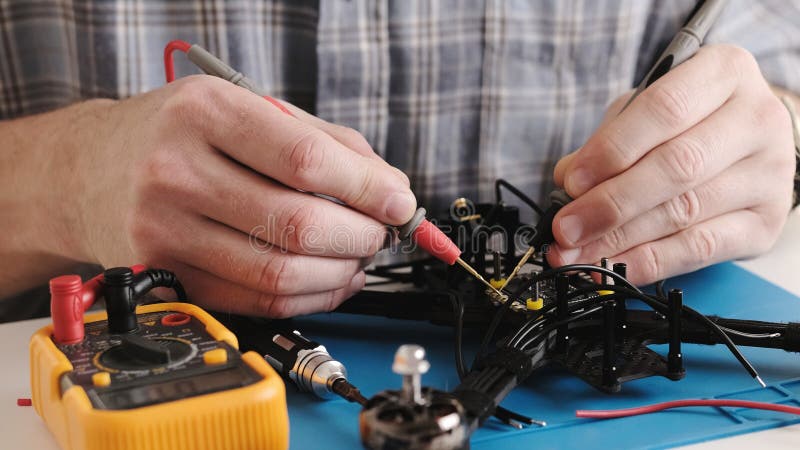 Masrter Cheching Circuit Connection On Microchip Board In Service Center stock photos