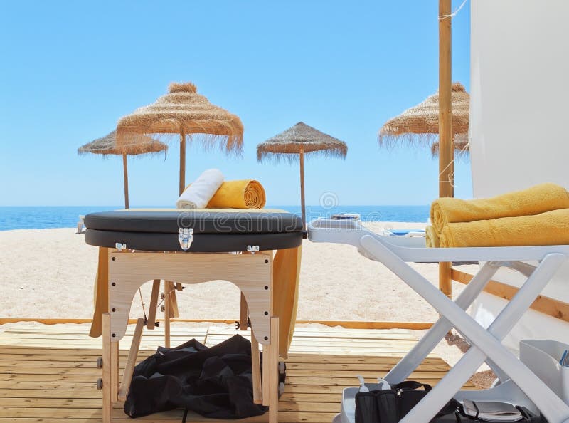Massage Area and a Deck Chair on the Beach for Therapy. Stock Photo