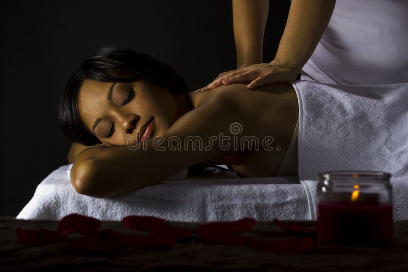 Massage in a dark room stock photo Massage in a dark room stock photo