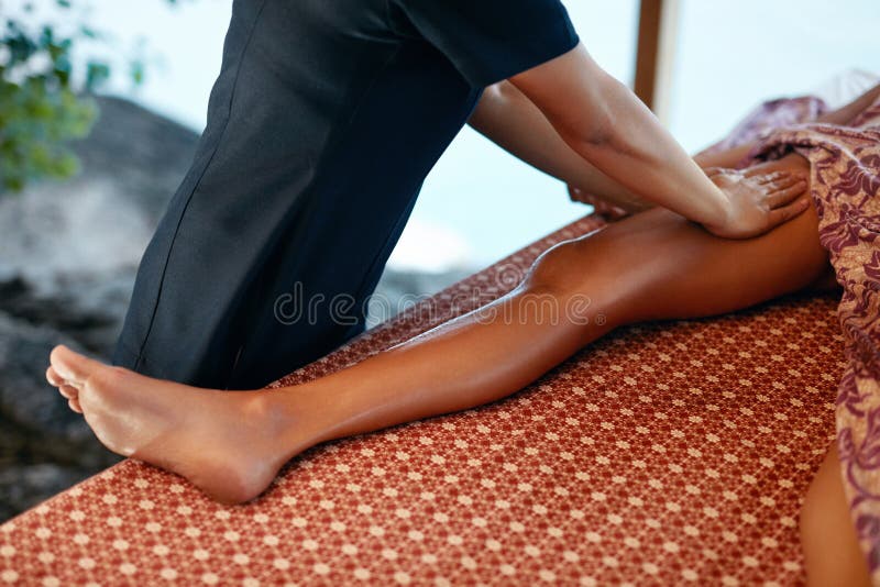 Leg Massage. Closeup Of Massaging Therapy With Oil At Thai Spa. Body Care Procedure At Massage Salon. High Resolution. Leg Massage. Closeup Of Massaging Therapy With Oil At Thai Spa. Body Care Procedure At Massage Salon. High Resolution