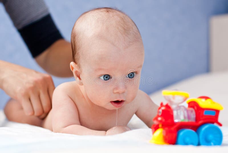 Massage newborn baby lying on his stomach