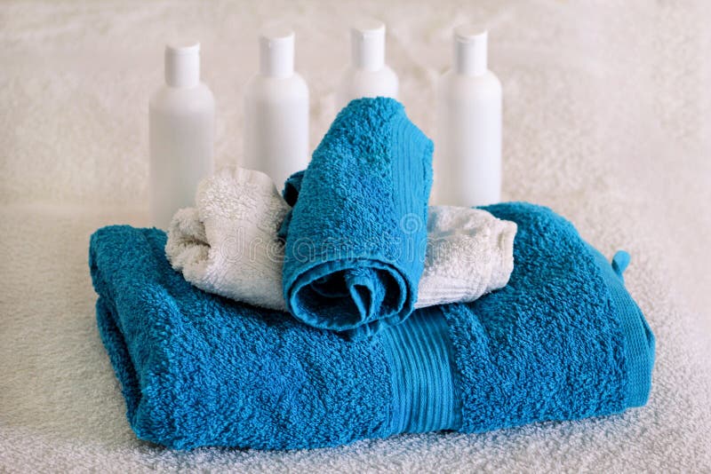 Massage table, towels and bottles with essential oil