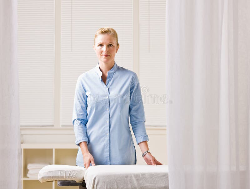 Massage Therapist Doing Massotherapy Of A Young Woman. Acupressure A