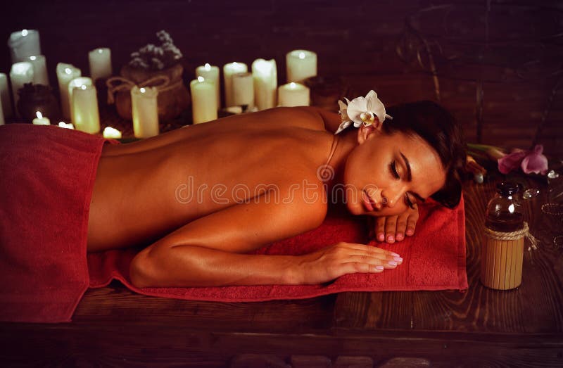 Massage of woman in spa salon. Luxary interior oriental therapy.