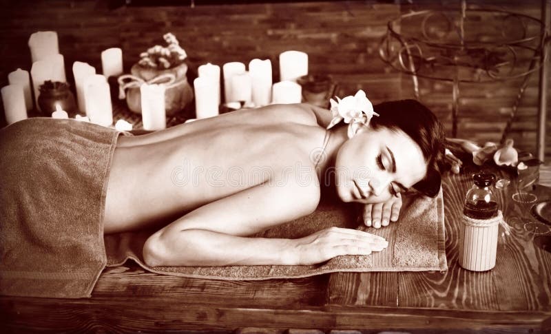 Massage of woman in spa salon. Luxary interior oriental therapy .