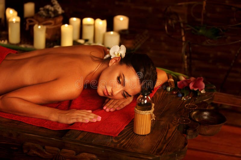 Massage of woman in spa salon. Luxary interior oriental therapy .