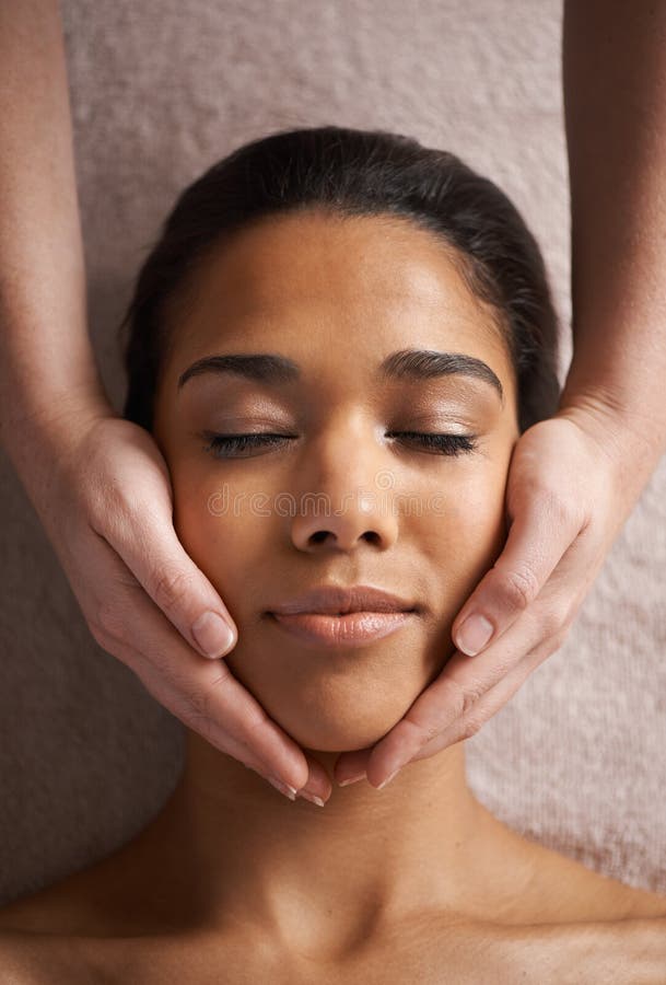 Massaging The Body And Mind A Beautiful Young Woman Getting A Head Massage At A Spa Stock