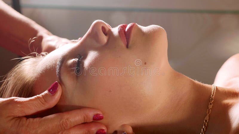 Masseur does head massage for pretty young woman in spa salon, close-up stock image Masseur does head massage for pretty young woman in spa salon, close-up stock image