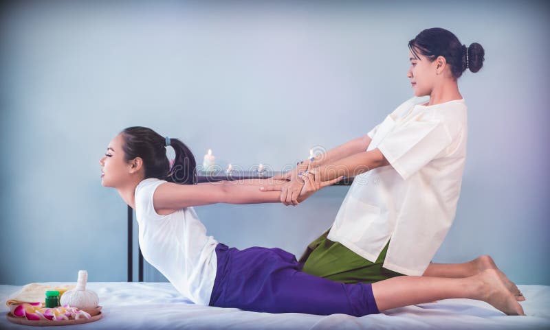 Masseur Is Giving Back Stretching Pulling Hand Of A Woman In Thai Massage Spa Resort Stock Image