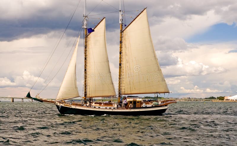 A view of a two masted sailboat or schooner under sail. A view of a two masted sailboat or schooner under sail.