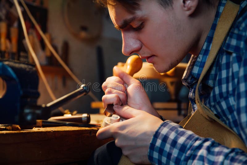 Master Artisan Luthier Working on the Creation of a Violin. Painstaking