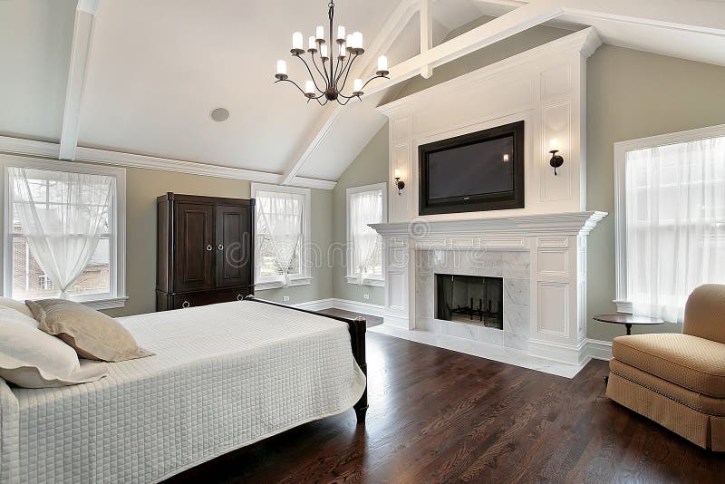Master bedroom with marble fireplace stock photos