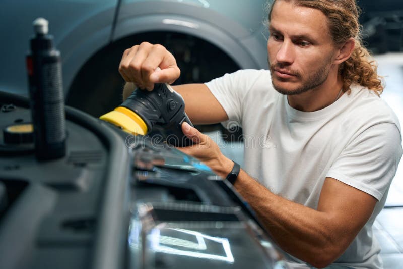 Master in a Car Repair Shop Cleans Car Headlights Stock Photo Image