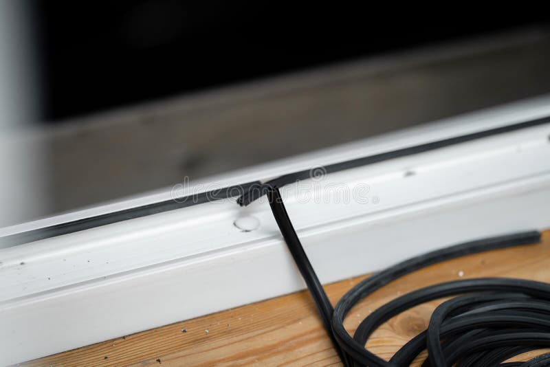 The Master Changes Rubber Seal Gasket in Pvc Windows Stock Photo
