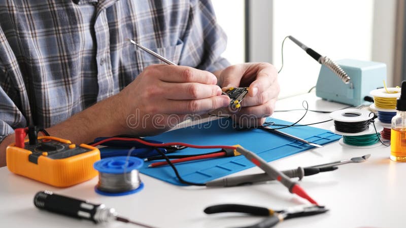 Master Checking Microchip Board In Repairs Workshop stock photo