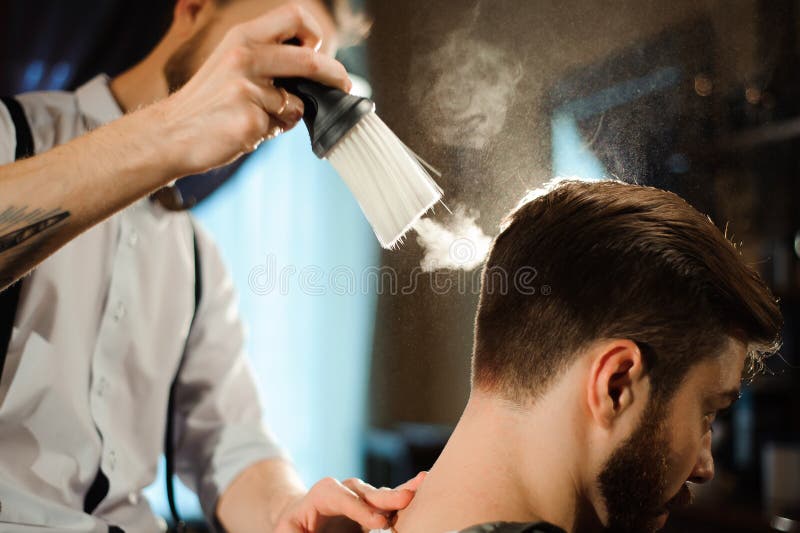 Master cuts hair and beard of men in the barbershop stock photography Master cuts hair and beard of men in the barbershop stock photography
