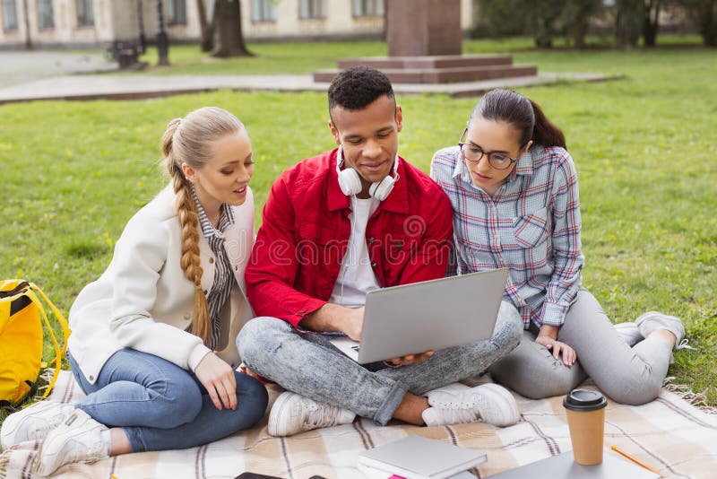 Master degree students watching memorable photos on laptop royalty free stock photos Master degree students watching memorable photos on laptop royalty free stock photos
