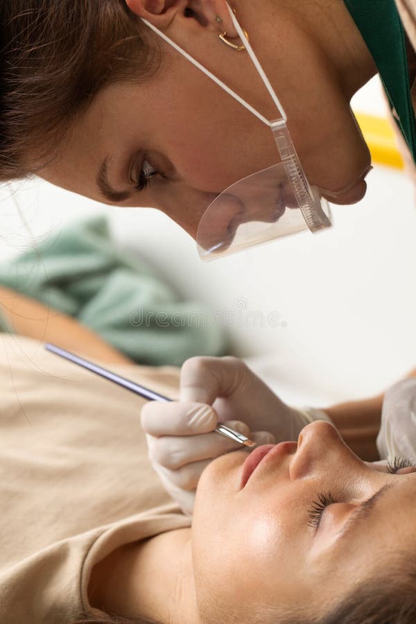 The Master Draws a Sketch before the Lip Permanent Procedure with a