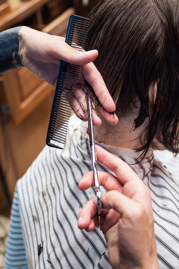 Master hairdresser cuts a man in the salon royalty free stock photo Master hairdresser cuts a man in the salon royalty free stock photo