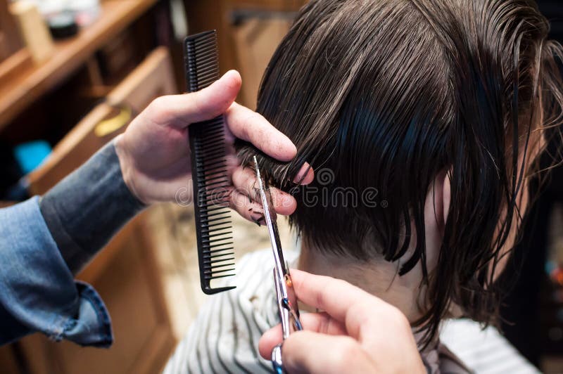 Master hairdresser cuts a man in the salon royalty free stock photography Master hairdresser cuts a man in the salon royalty free stock photography