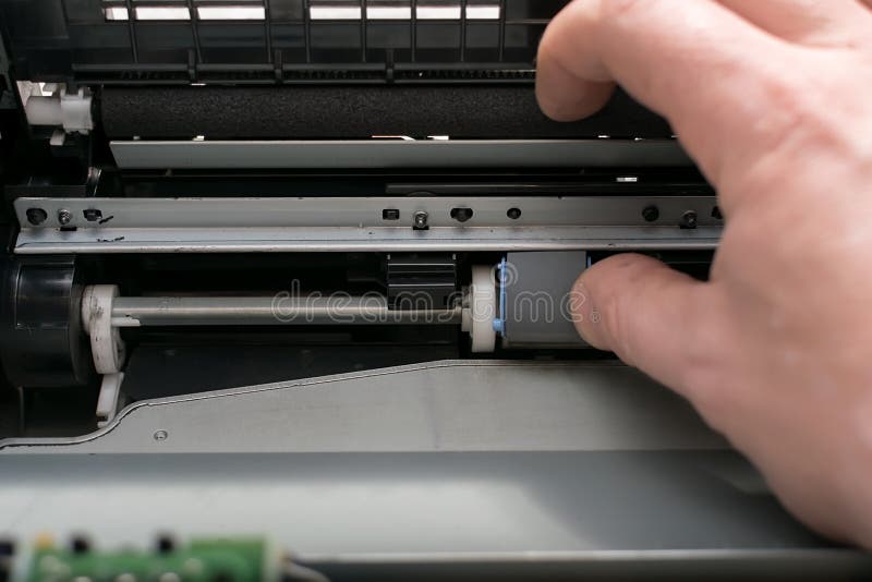 The Master Hand Changes the Rubber Grip Roller in the Printer Stock