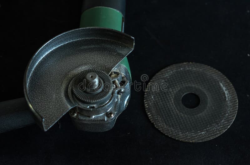 The Master Installs the Cutting Wheel in the Angle Grinder Stock Photo