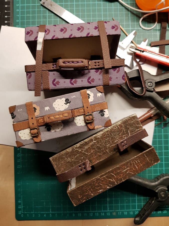 Craftsman makes miniature doll suitcases royalty free stock photo