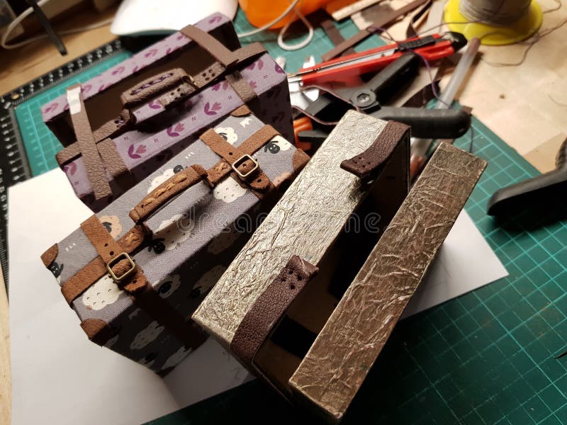 Craftsman makes miniature doll suitcases stock images