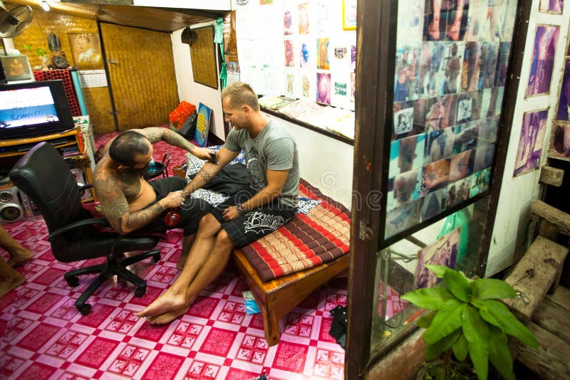 Unidentified master makes traditional tattoo bamboo, Jan 27, 2012 in Chang, Thailand. Thai tattooists are very popular among tourists, prices range from 500 thai baht and up.