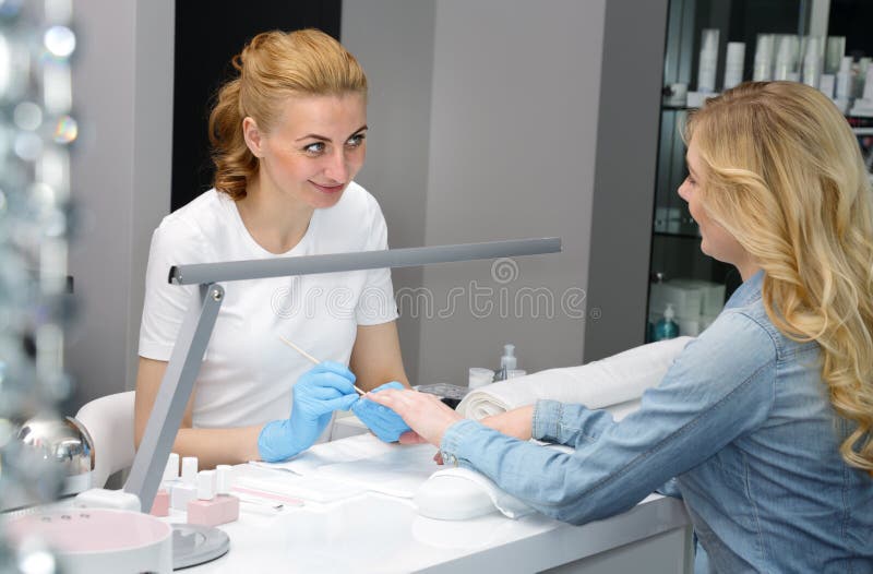 Master of manicure is working on hands Girl royalty free stock image Master of manicure is working on hands Girl royalty free stock image