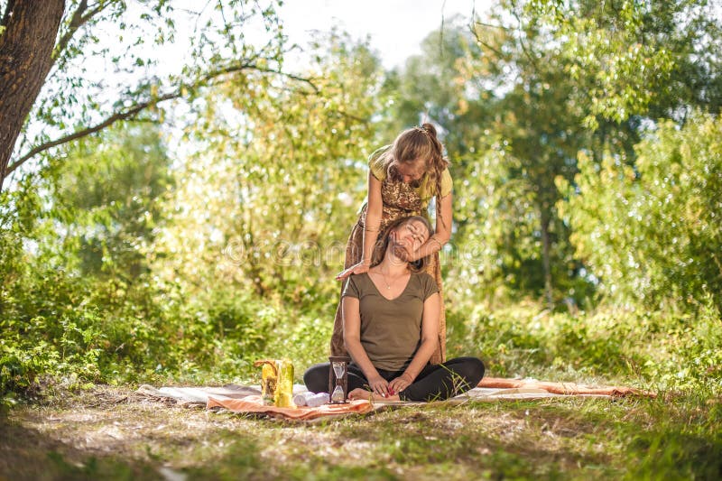 Master Massage Therapist Thuroughly Massages A Girl In Nature Stock